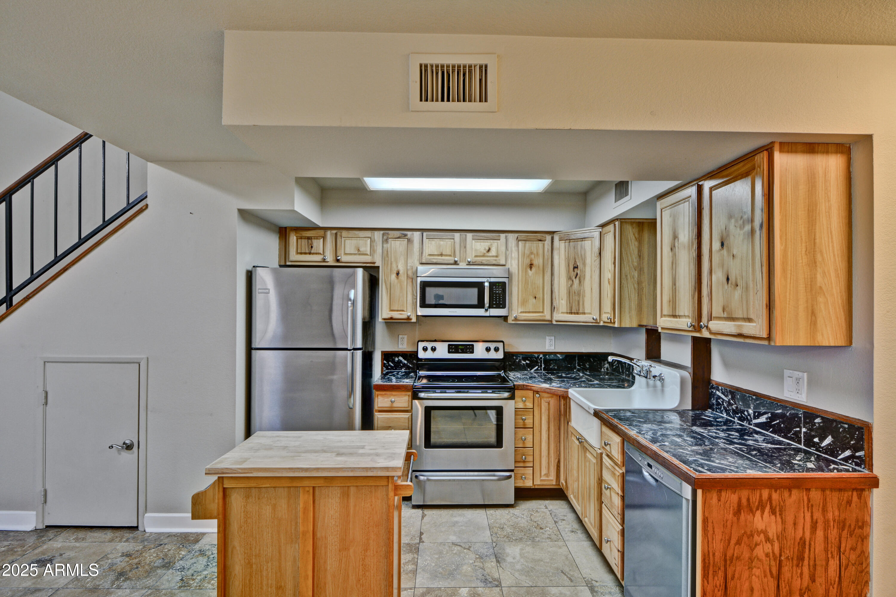 602 North May, Unit 17 Mesa, AZ 85201 - Photo 13 of 39 a kitchen with stainless steel appliances granite countertop a stove a sink and a refrigerator