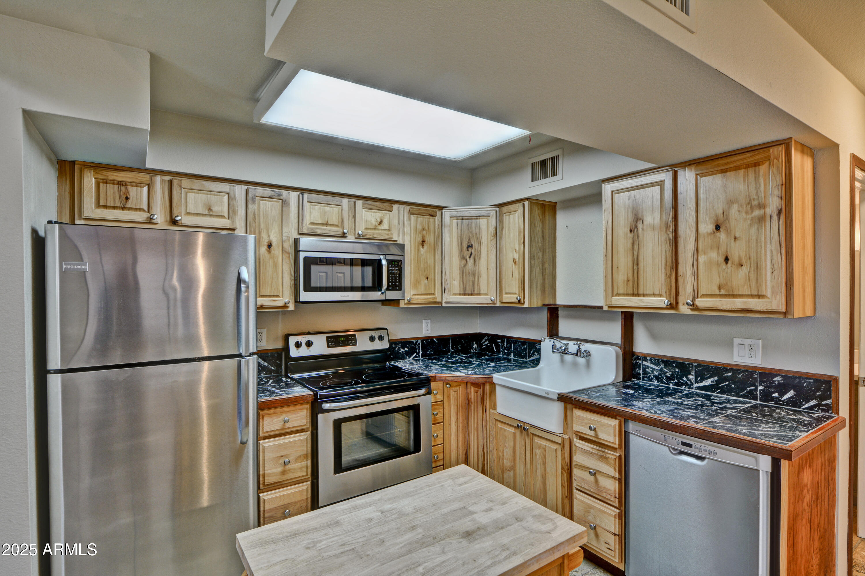 602 North May, Unit 17 Mesa, AZ 85201 - Photo 14 of 39 a kitchen with stainless steel appliances granite countertop a refrigerator stove microwave and sink