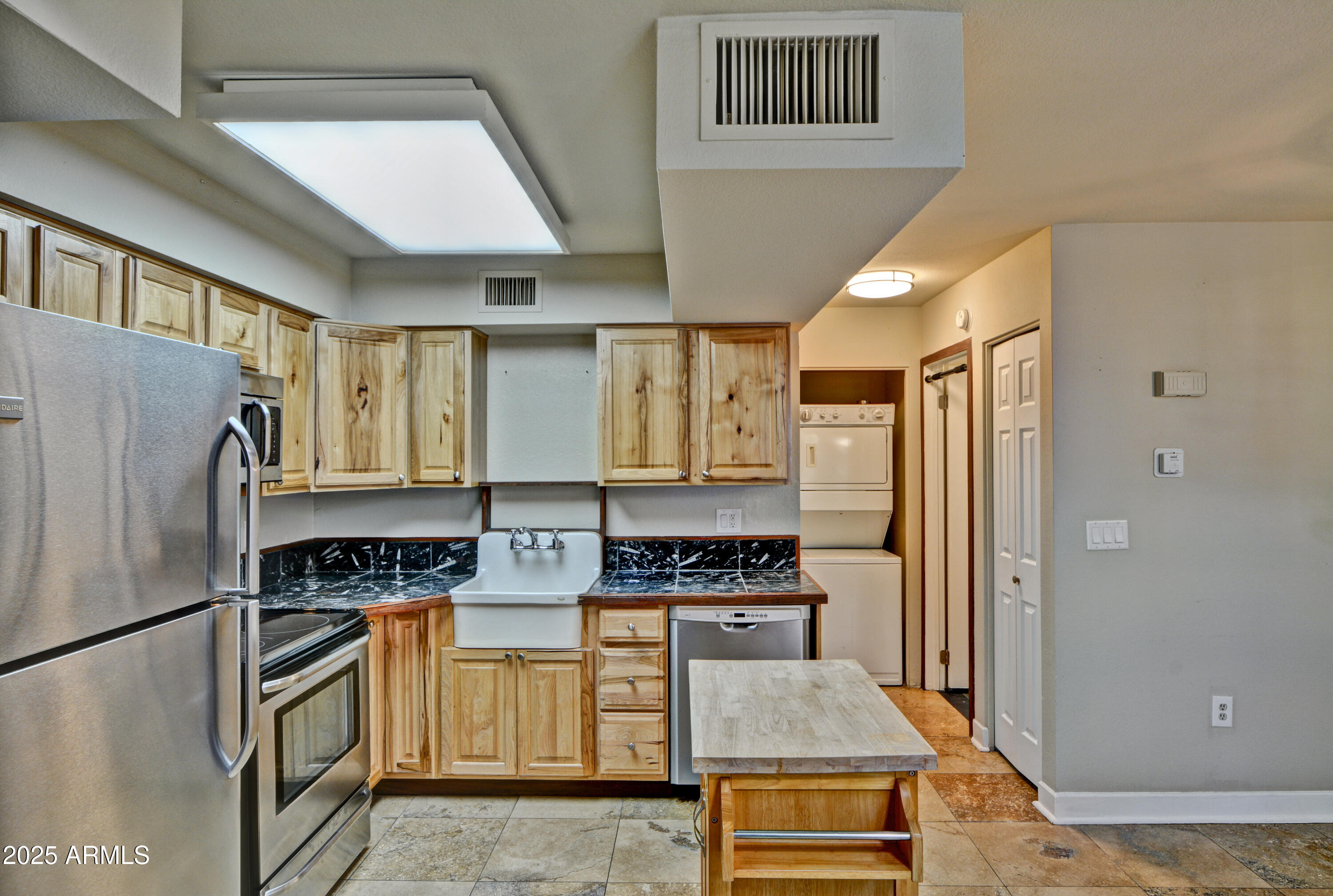 602 North May, Unit 17 Mesa, AZ 85201 - Photo 15 of 39 a kitchen with stainless steel appliances granite countertop a refrigerator a stove and a sink
