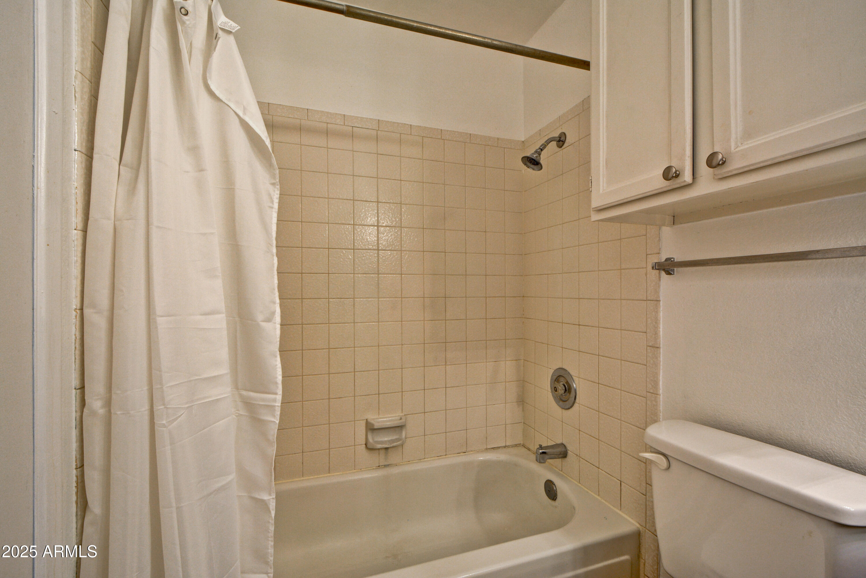 602 North May, Unit 17 Mesa, AZ 85201 - Photo 27 of 39 a white bath tub sitting next to a white toilet and vanity