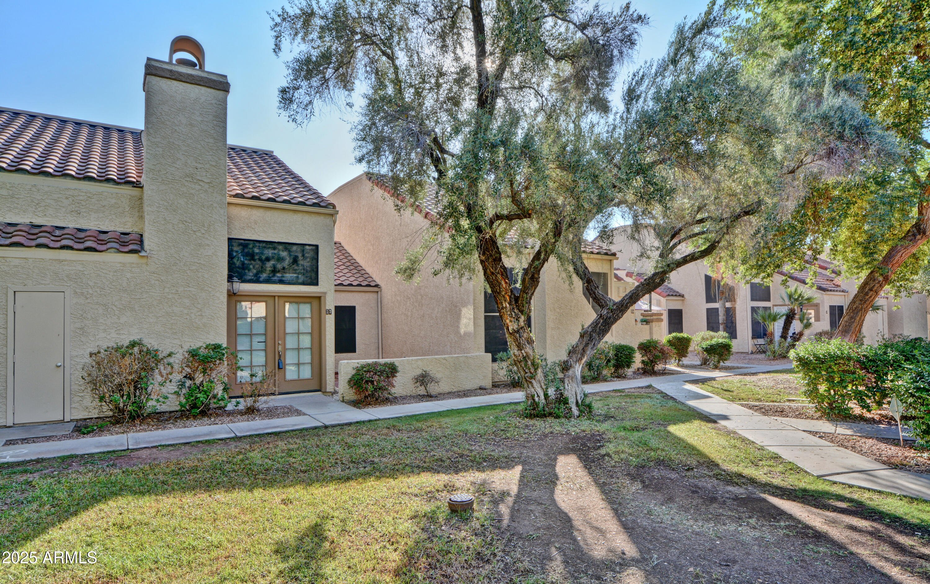 602 North May, Unit 17 Mesa, AZ 85201 - Photo 3 of 39 a front view of a house with garden