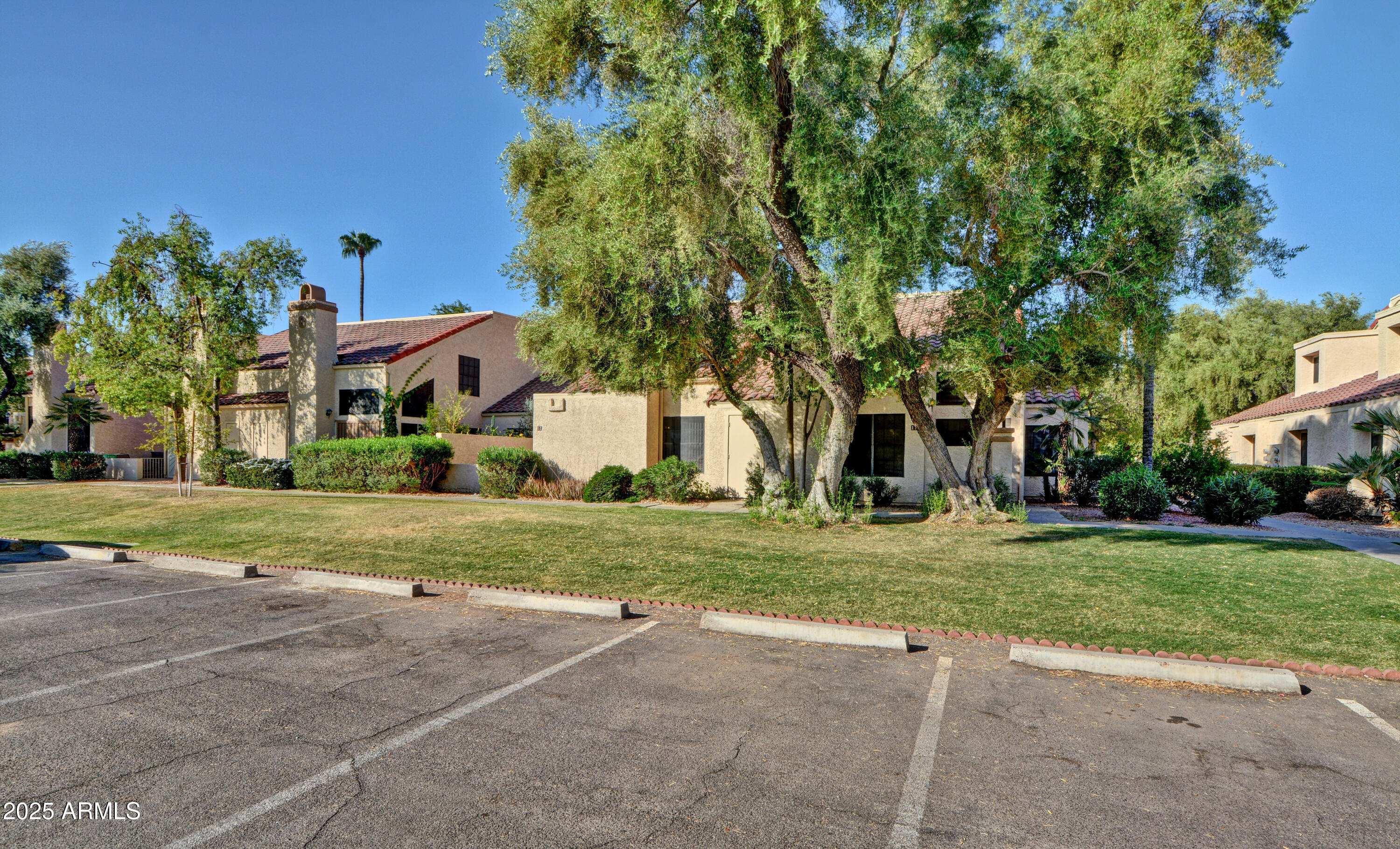 602 North May, Unit 17 Mesa, AZ 85201 - Photo 38 of 39 a front view of a house with a yard and trees