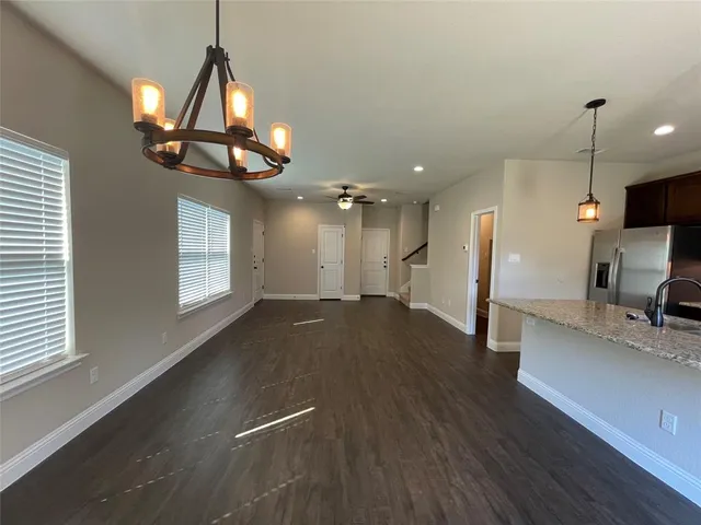 a view of a kitchen with a sink and a chandelier