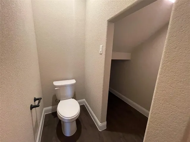 a white toilet sitting in a bathroom