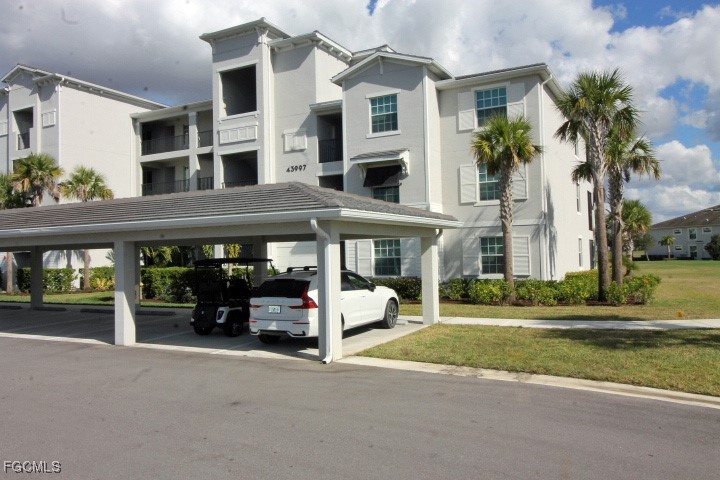 43997 Boardwalk Loop, Unit 1816 Punta Gorda, FL 33982 - Photo 16 of 44 a view of building with car parked