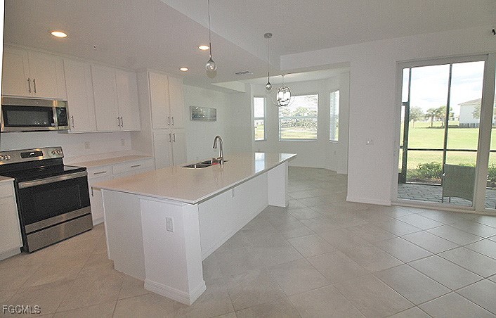 43997 Boardwalk Loop, Unit 1816 Punta Gorda, FL 33982 - Photo 3 of 44 a kitchen with a sink stove and cabinets