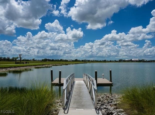 43997 Boardwalk Loop, Unit 1816 Punta Gorda, FL 33982 - Photo 40 of 44 a view of a lake with a mountain in the background
