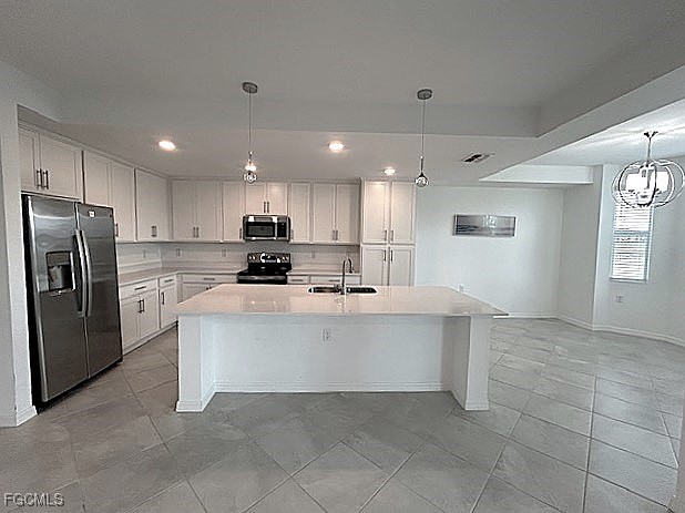 43997 Boardwalk Loop, Unit 1816 Punta Gorda, FL 33982 - Photo 4 of 44 a large white kitchen with a refrigerator a stove top oven and cabinets