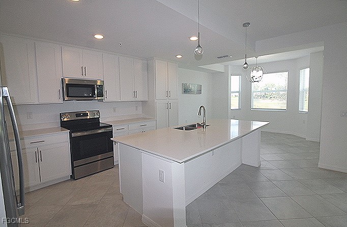 43997 Boardwalk Loop, Unit 1816 Punta Gorda, FL 33982 - Photo 6 of 44 a kitchen with a sink stove and microwave