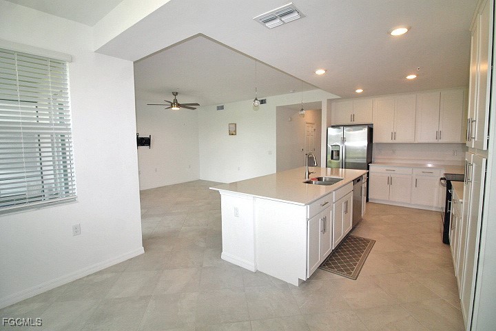 43997 Boardwalk Loop, Unit 1816 Punta Gorda, FL 33982 - Photo 7 of 44 a kitchen with kitchen island a sink stove and refrigerator