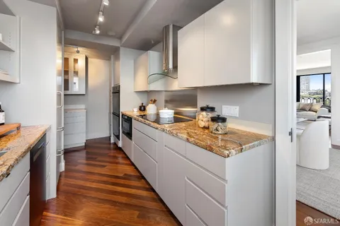 a kitchen with stainless steel appliances a sink stove and cabinets