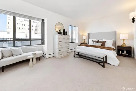 a view of walk in closet with clothes and window