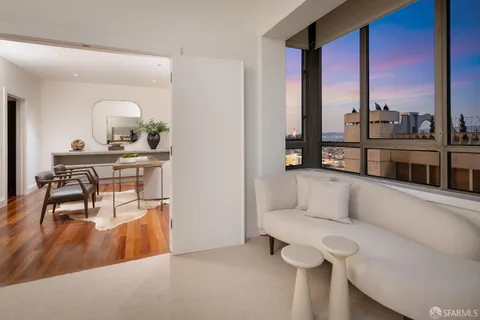 a dining room with furniture and wooden floor