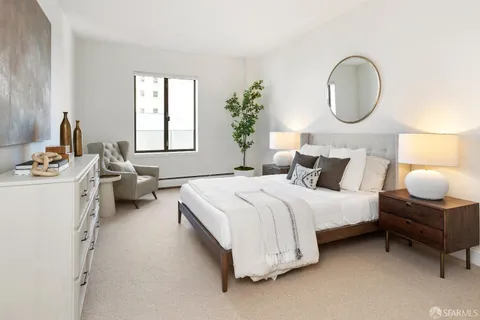 a bedroom with bed and a night stand