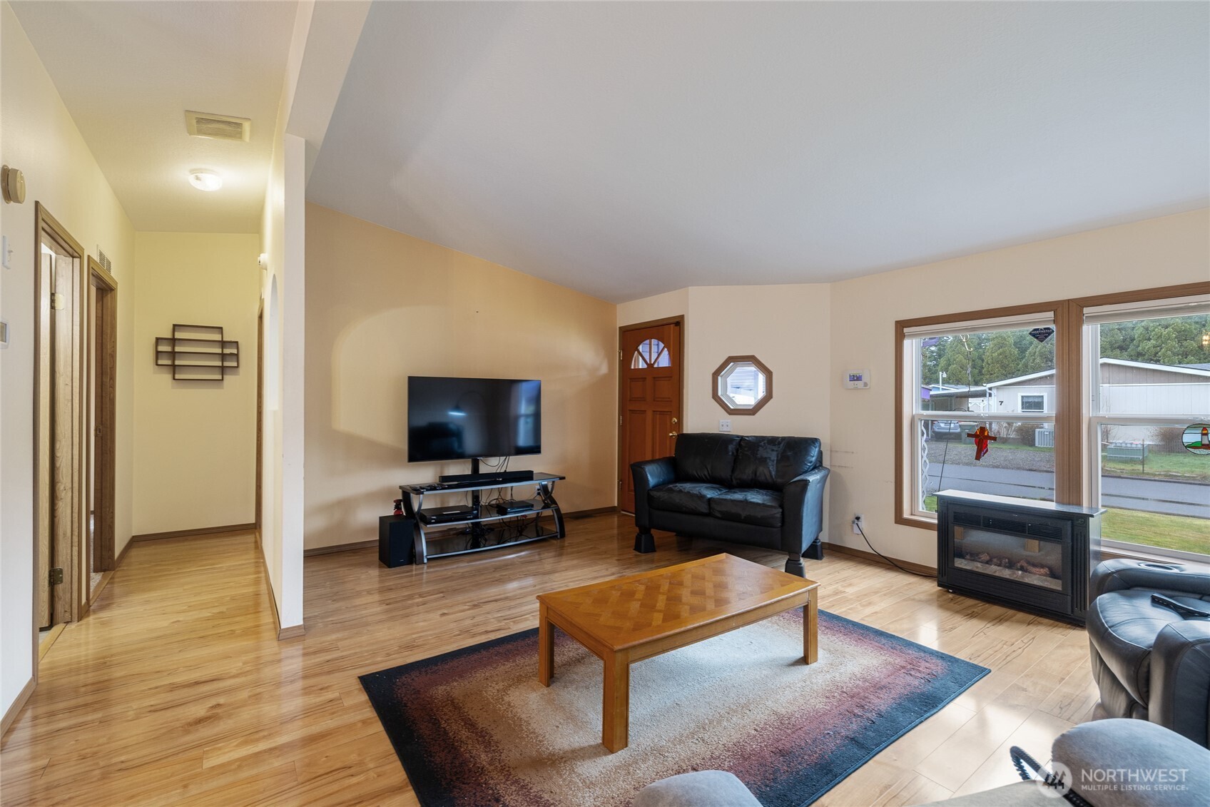 19300 Pecan Street Southwest, Unit 10 Rochester, WA 98579 - Photo 6 of 40 a living room with furniture and a flat screen tv