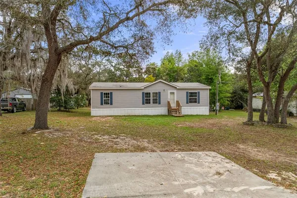 a view of a house with a backyard