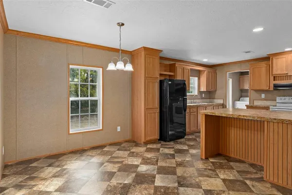a kitchen with stainless steel appliances granite countertop a refrigerator a stove a sink and a oven