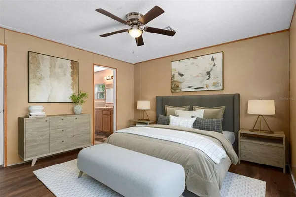 a bedroom with a large bed and a chandelier