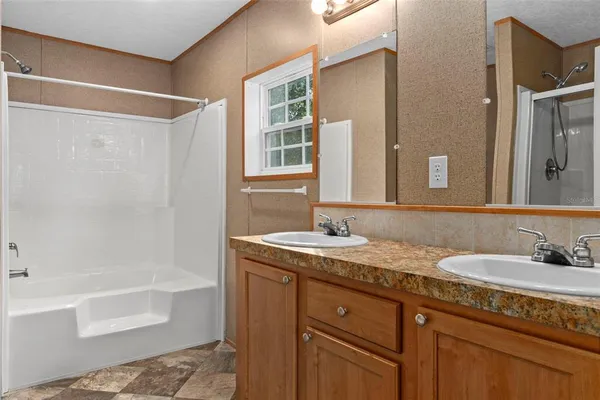 a bathroom with a granite countertop sink and a bathtub