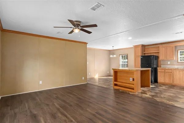 a view of room with wooden floor and windows