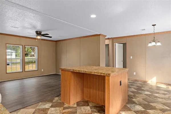 a spacious bathroom with a granite countertop sink and a mirror