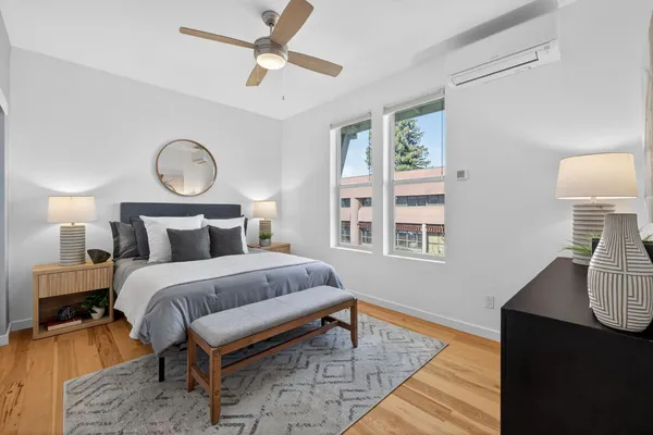 a bedroom with bed and wooden floor