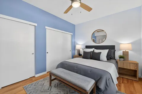 a bedroom with a bed and a chandelier