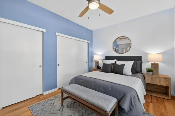 a bedroom with a bed and a chandelier