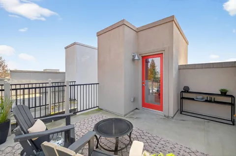a view of a chairs and table in the balcony