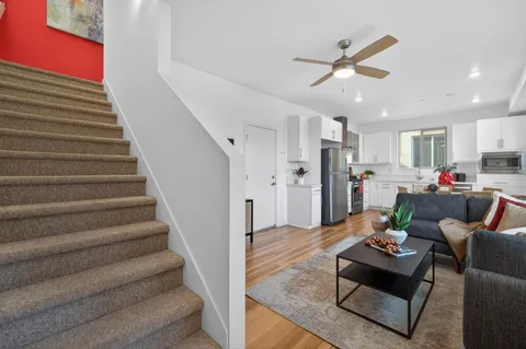 a living room with furniture and kitchen view