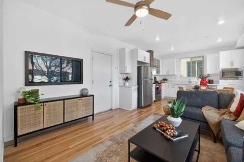 a living room with furniture and kitchen view