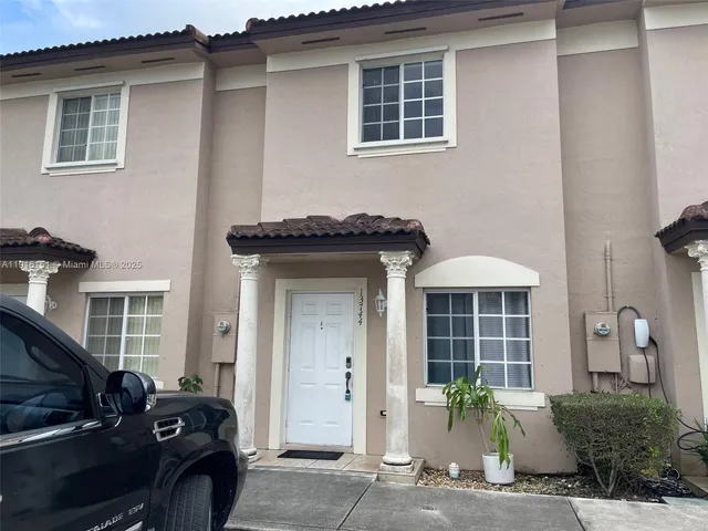 a front view of a house with parking
