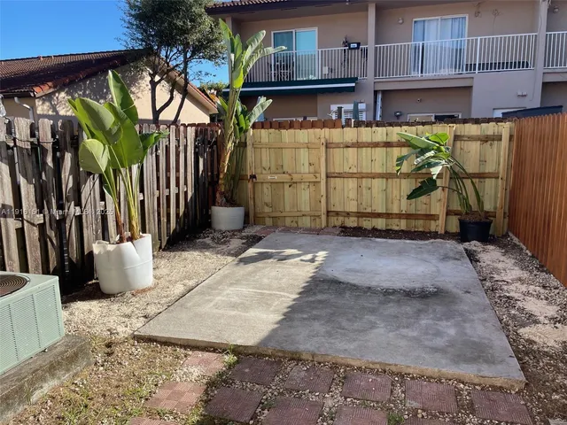 a view of a house with a wooden fence