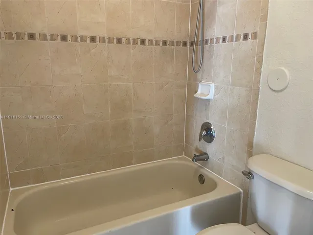 a bathroom with a bathtub and a toilet