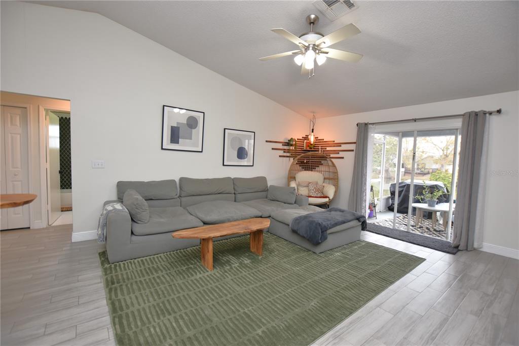 2022 Hatteras Point Lakeland, FL 33813 - Photo 15 of 36 a living room with furniture and a fireplace
