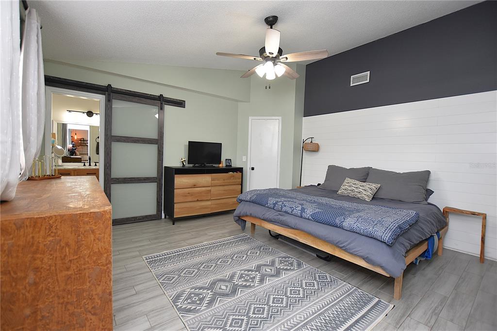 2022 Hatteras Point Lakeland, FL 33813 - Photo 16 of 36 a spacious bedroom with a bed and a chandelier