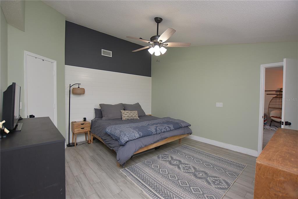 2022 Hatteras Point Lakeland, FL 33813 - Photo 17 of 36 a bedroom with a bed dresser and a computer on a table