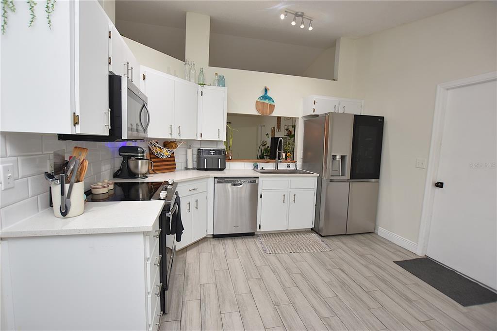 2022 Hatteras Point Lakeland, FL 33813 - Photo 4 of 36 a view of a kitchen with sink and wooden floor