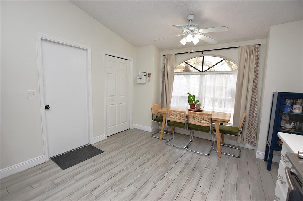 2022 Hatteras Point Lakeland, FL 33813 - Photo 8 of 36 an empty room with wooden floor fan and windows