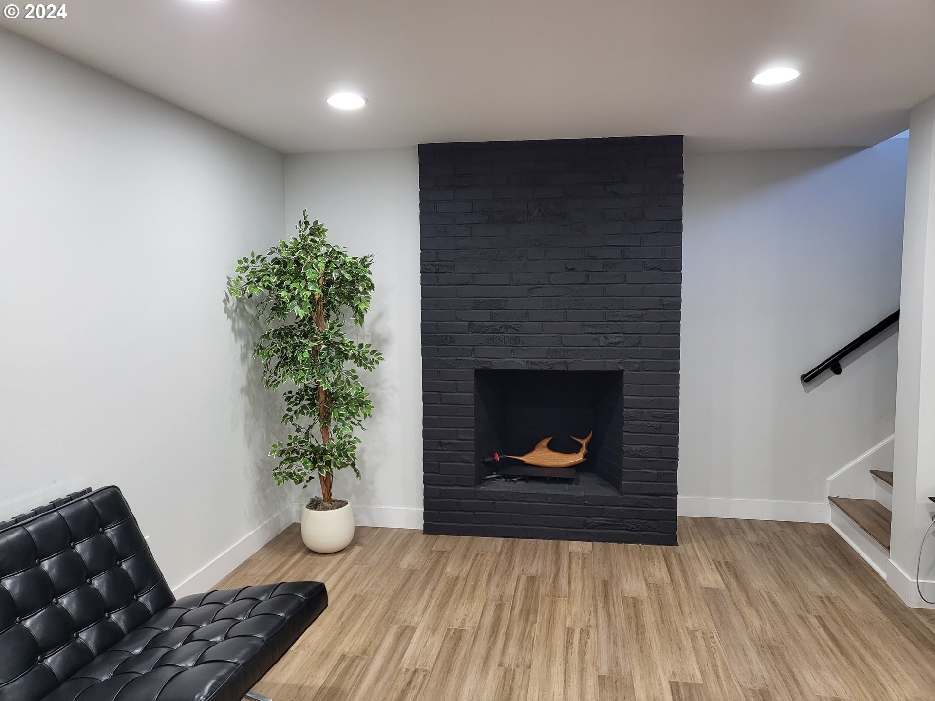 949 Southeast 221st Avenue Gresham, OR 97030 - Photo 11 of 19 a living room with a fireplace and wooden floor