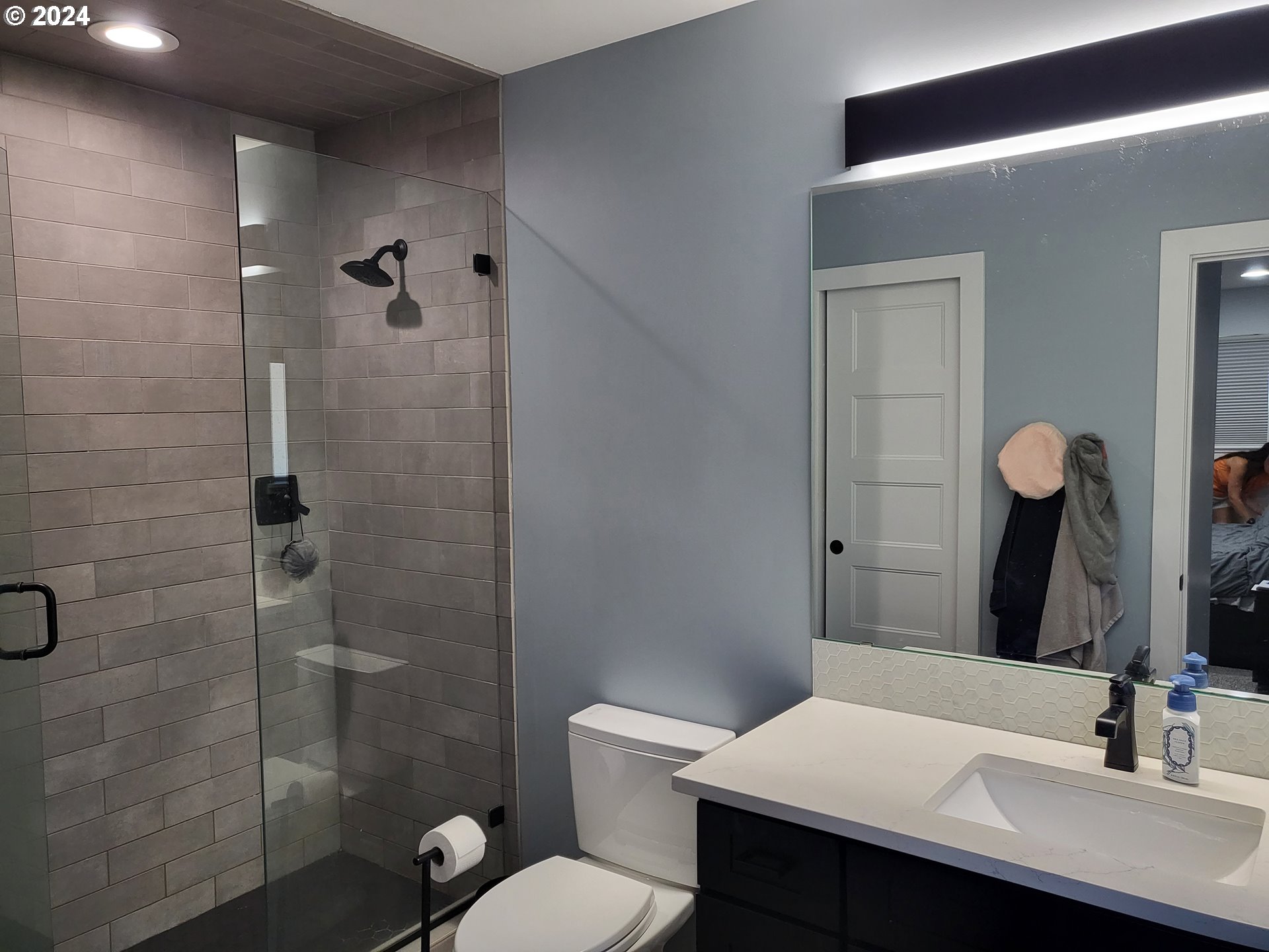 949 Southeast 221st Avenue Gresham, OR 97030 - Photo 12 of 19 a bathroom with a sink toilet a mirror and shower