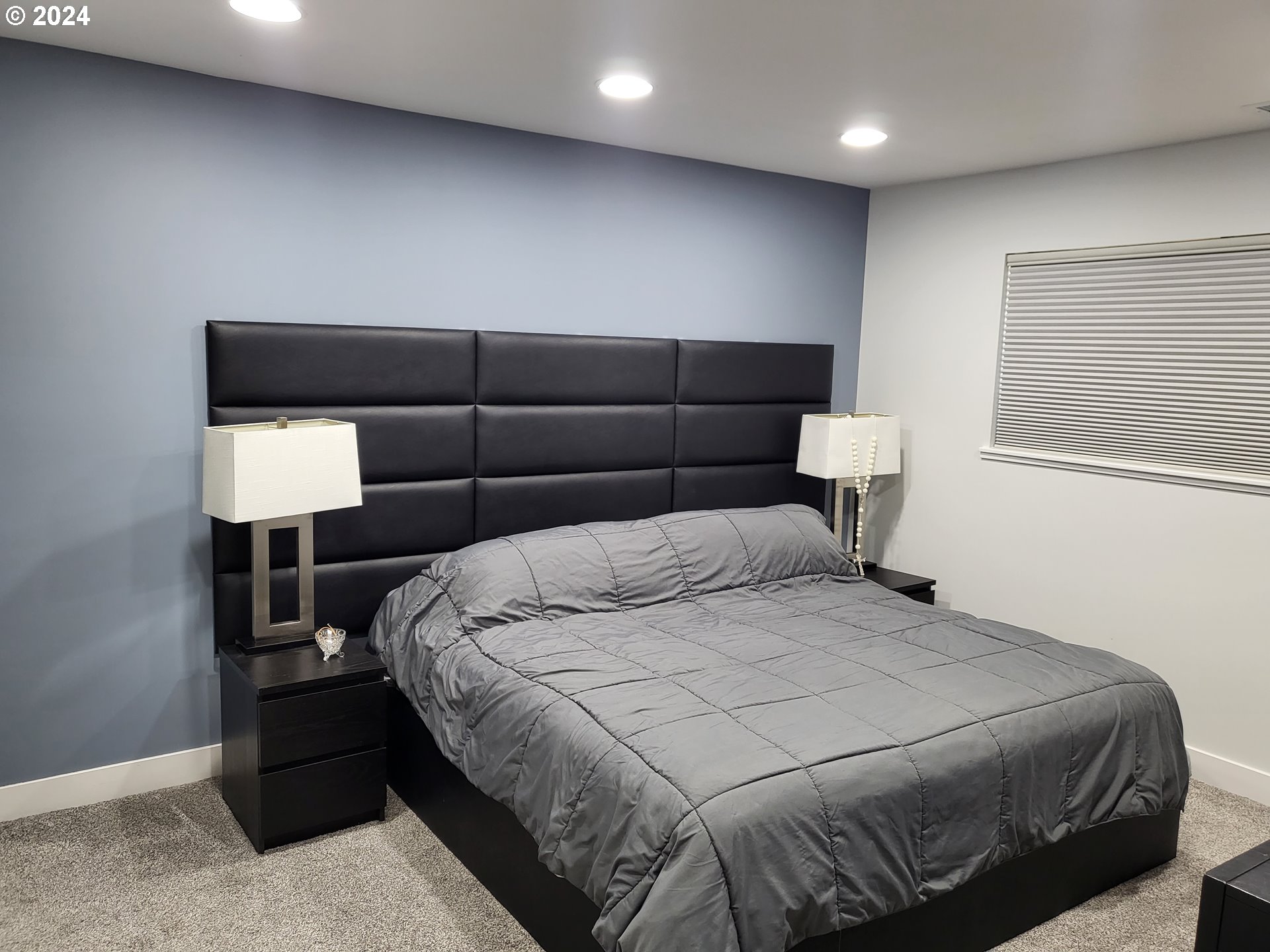 949 Southeast 221st Avenue Gresham, OR 97030 - Photo 15 of 19 a bedroom with a bed and a lamp