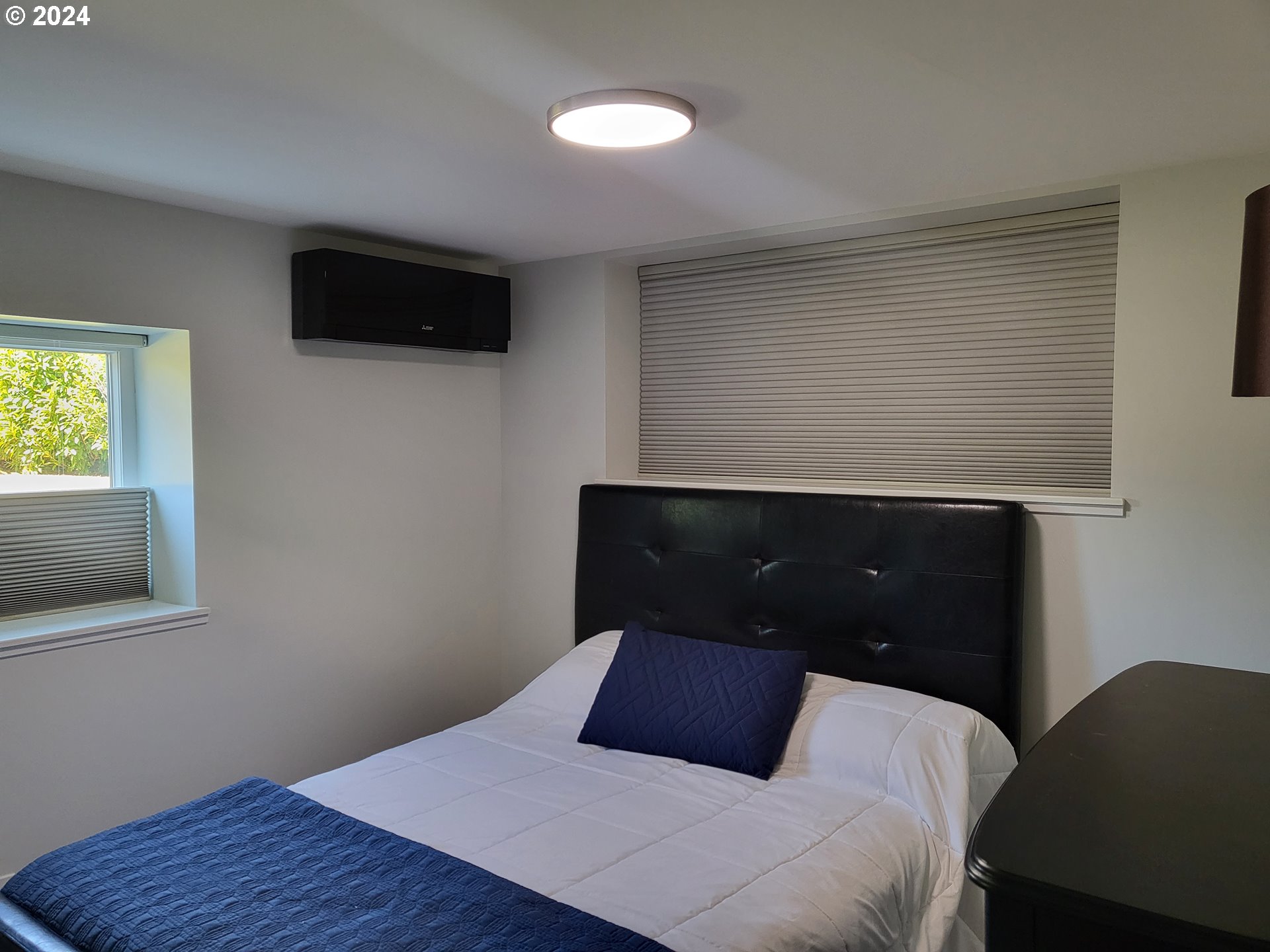 949 Southeast 221st Avenue Gresham, OR 97030 - Photo 18 of 19 a bedroom with a bed and a television