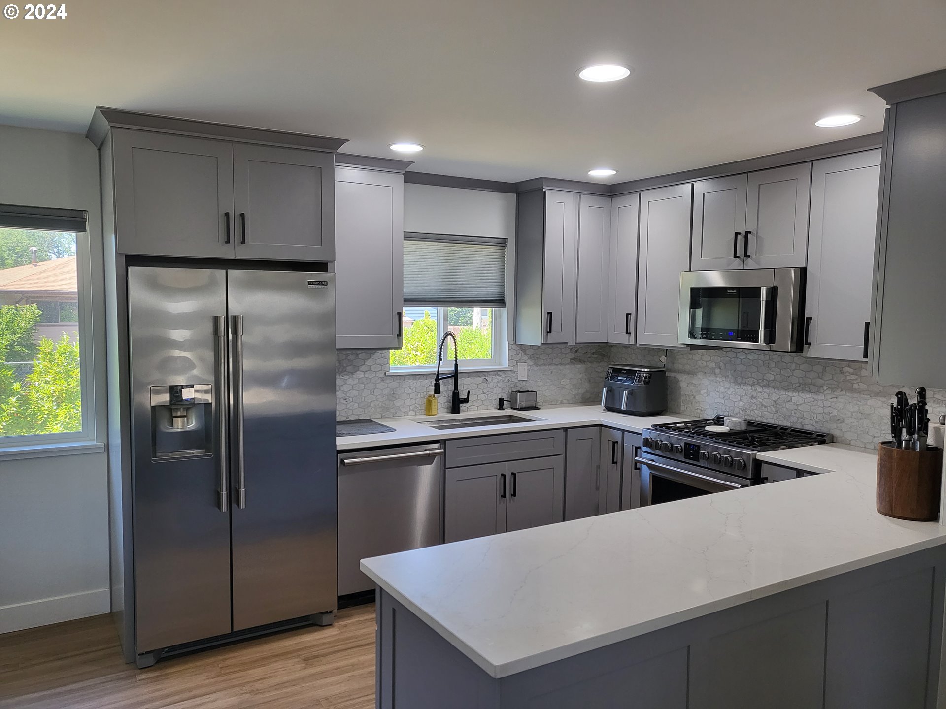 949 Southeast 221st Avenue Gresham, OR 97030 - Photo 3 of 19 a kitchen with a refrigerator a sink a stove and cabinets