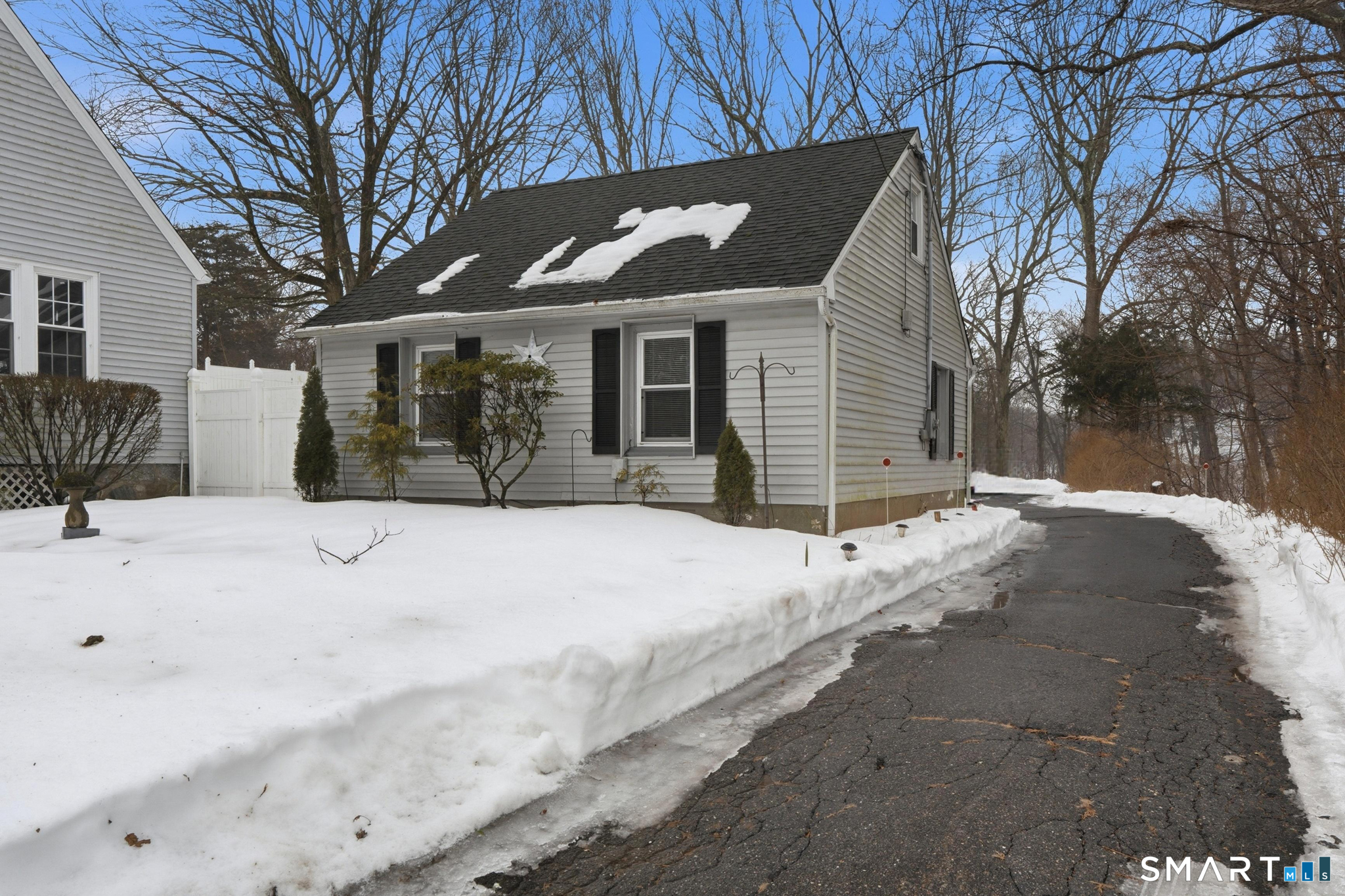 1565 Byam Road Cheshire, CT 06410 - Photo 1 of 18 a view of a white house with a yard covered in snow