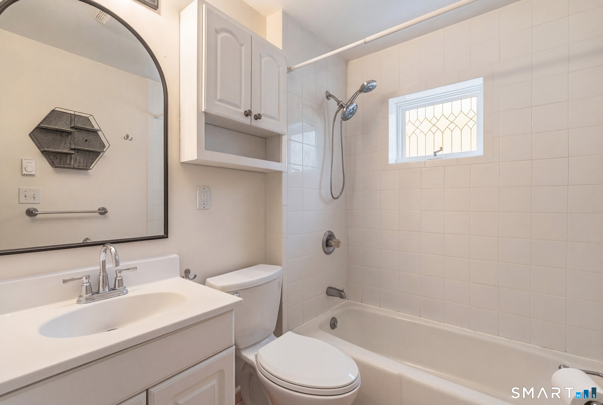1565 Byam Road Cheshire, CT 06410 - Photo 12 of 18 a bathroom with a toilet sink vanity tub and mirror