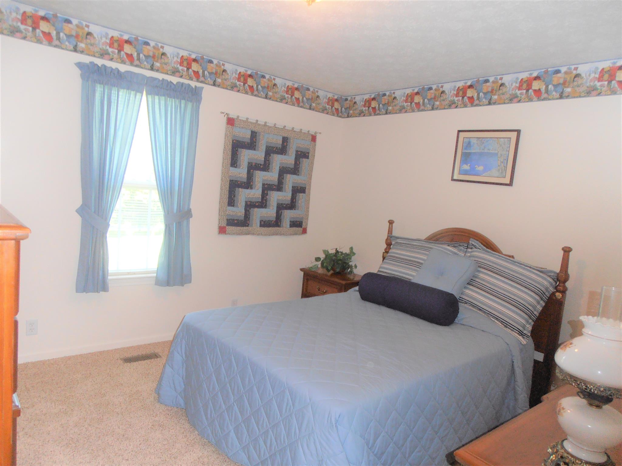 1141 Woods Ferry Road Lebanon, TN 37087 - Photo 19 of 30 a bedroom with a bed and a dresser next to a window