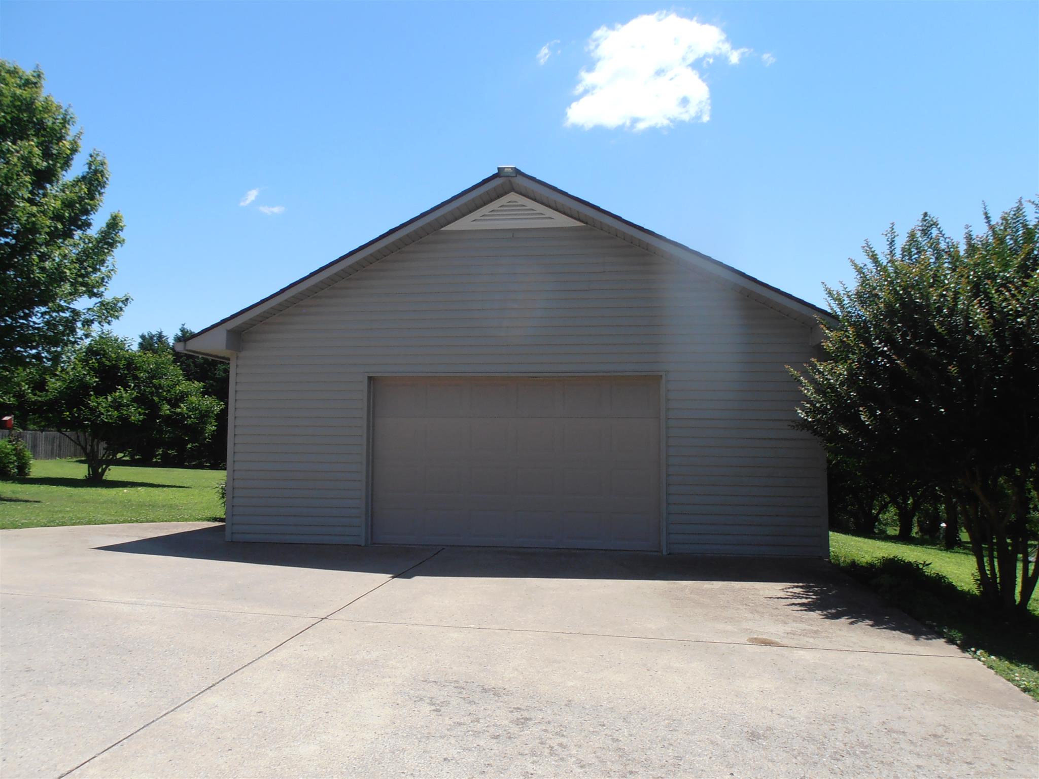 1141 Woods Ferry Road Lebanon, TN 37087 - Photo 25 of 30 a front view of a house with a yard and garage