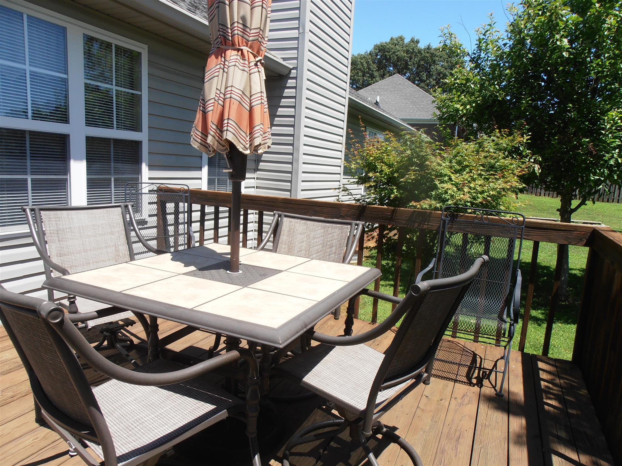 1141 Woods Ferry Road Lebanon, TN 37087 - Photo 4 of 30 a view of a patio with table and chairs with wooden floor and fence
