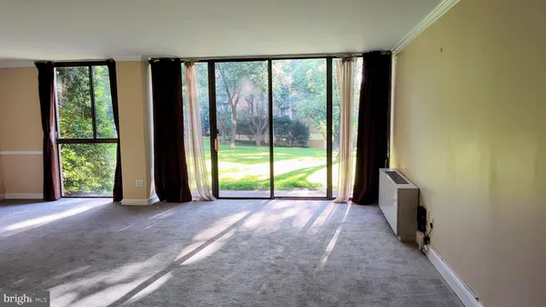 a view of a room with large windows and a flat screen tv